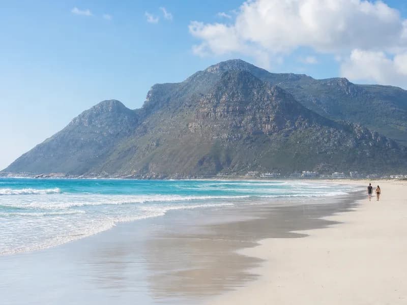 The empty white sand of Noordhoek beach on a clear afternoon